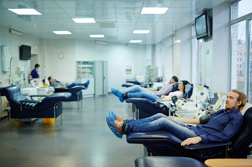 Several donors sitting in blood transfusion center